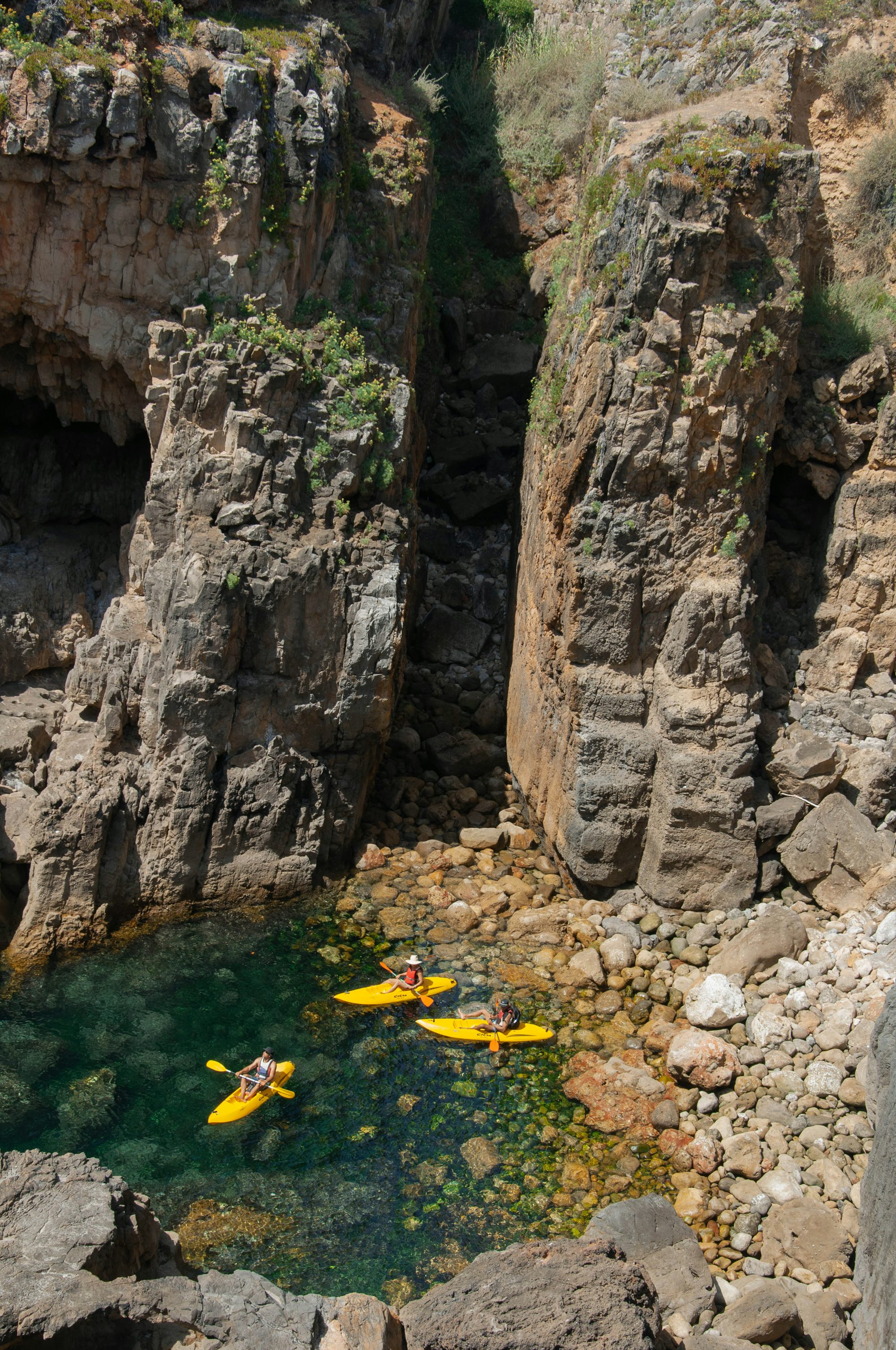 a group of people in yellow kayaks in the water